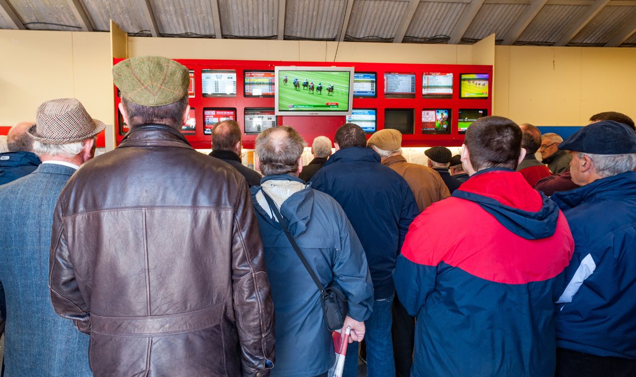 Listowel - September 20 2014: People watching live horse racing at a bookies centre in the republic of Ireland