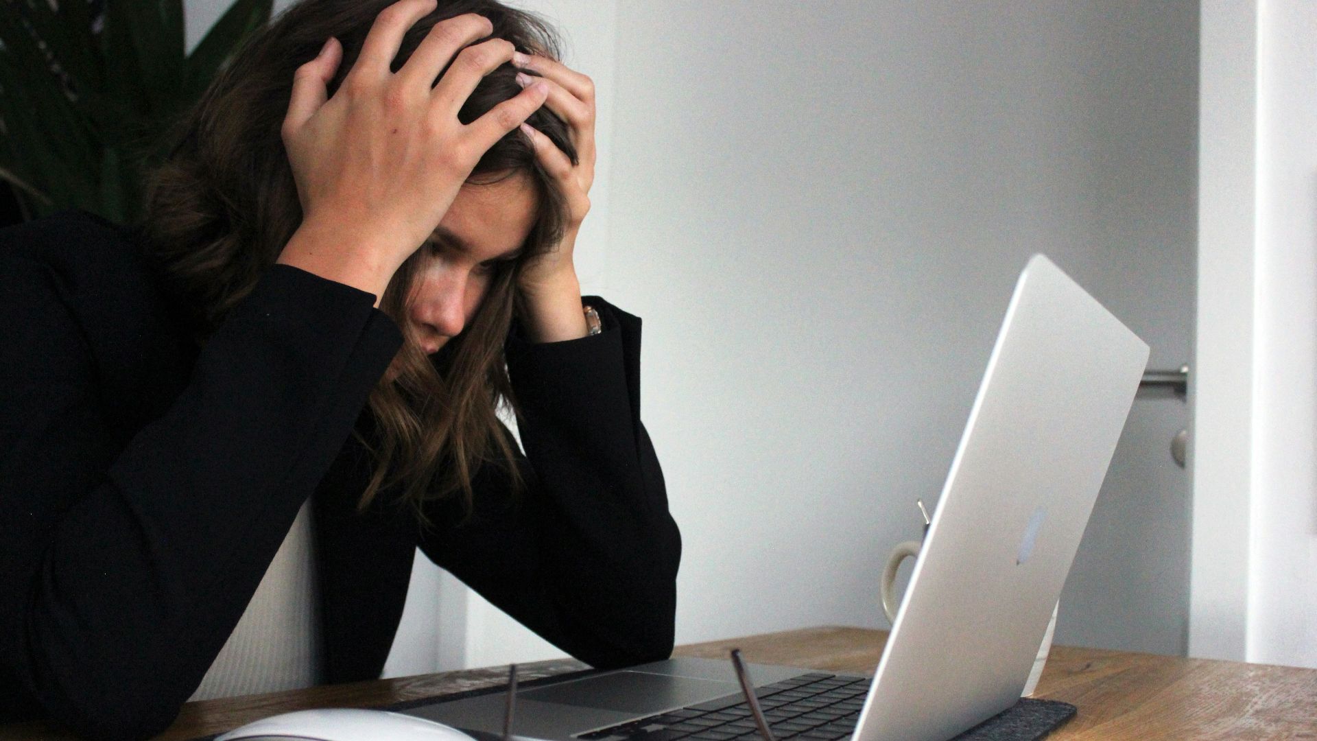 a woman sitting in front of a laptop computer