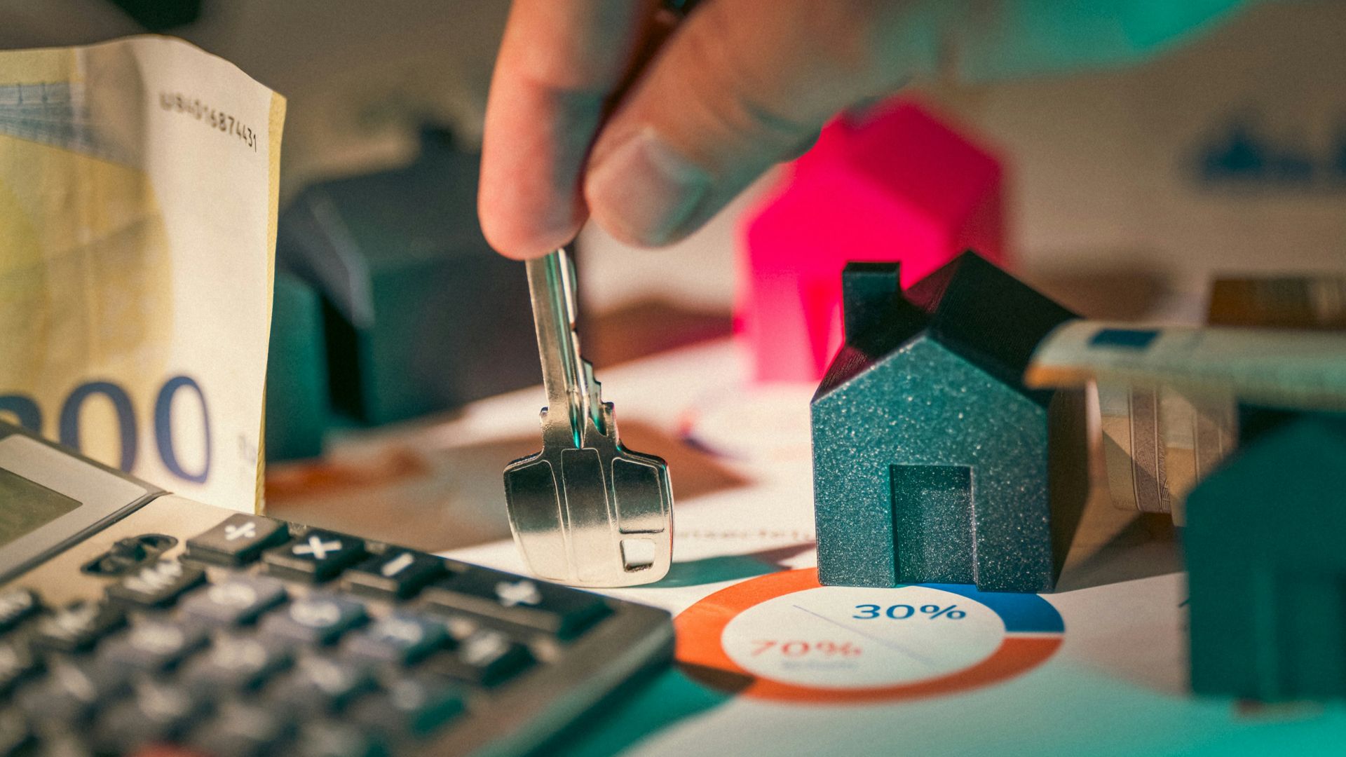 A person putting money into a calculator