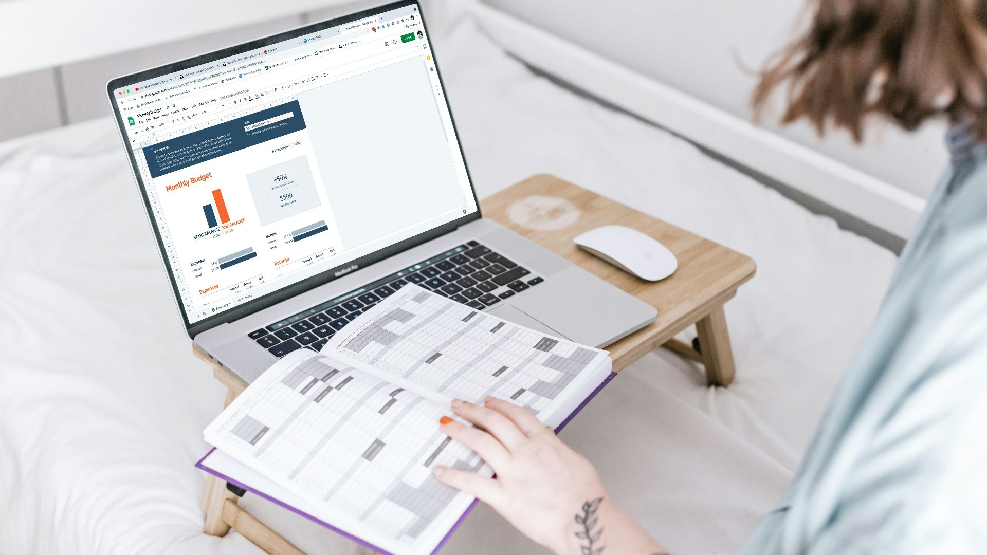 a person sitting on a bed with a laptop