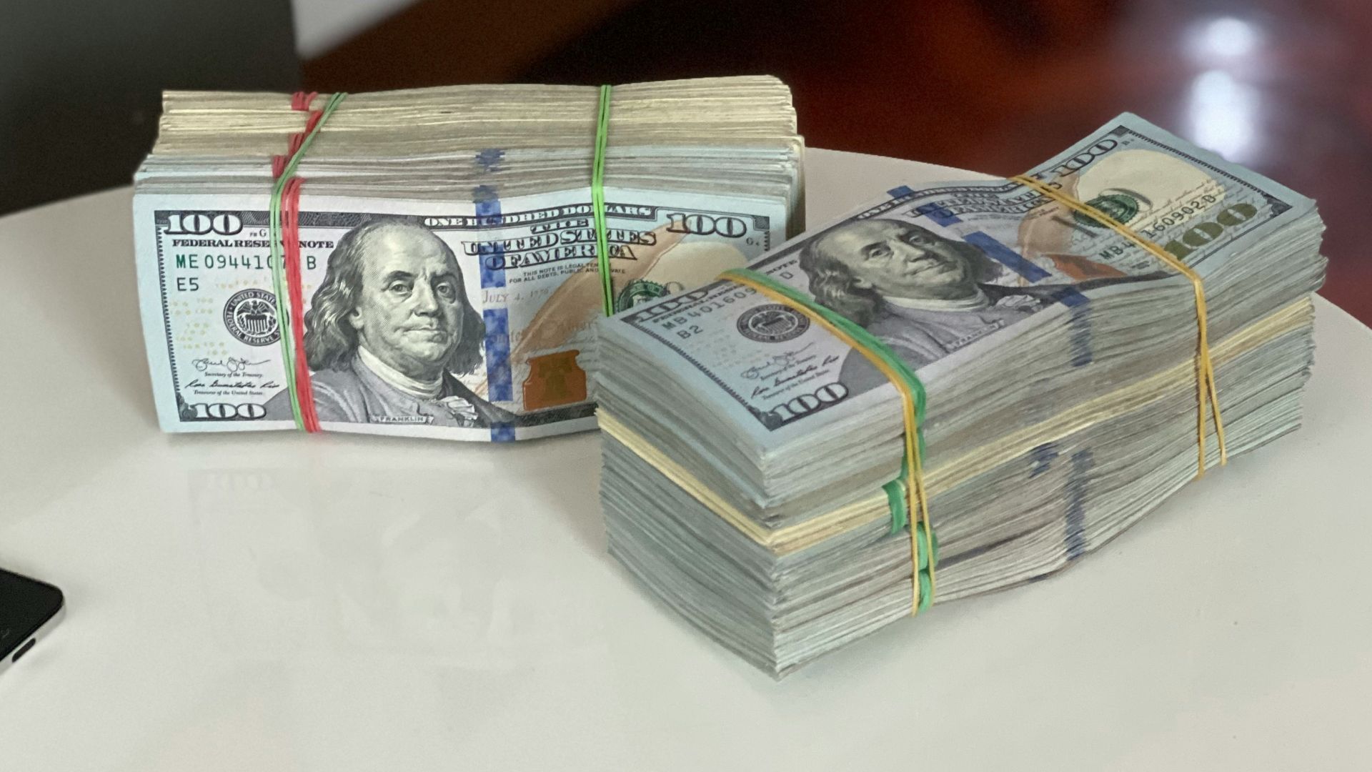 a stack of money sitting on top of a white table