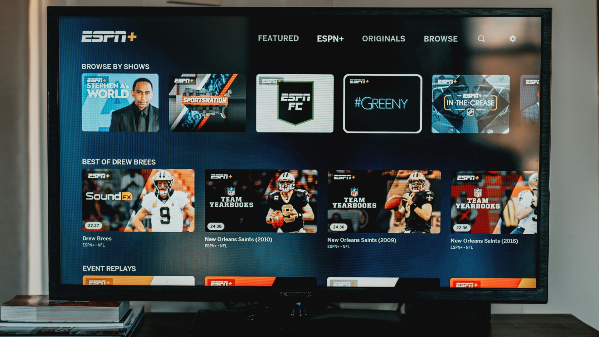 a flat screen tv sitting on top of a wooden table