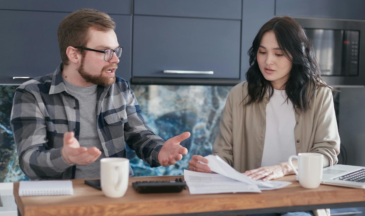 An upset man talking to a woman 