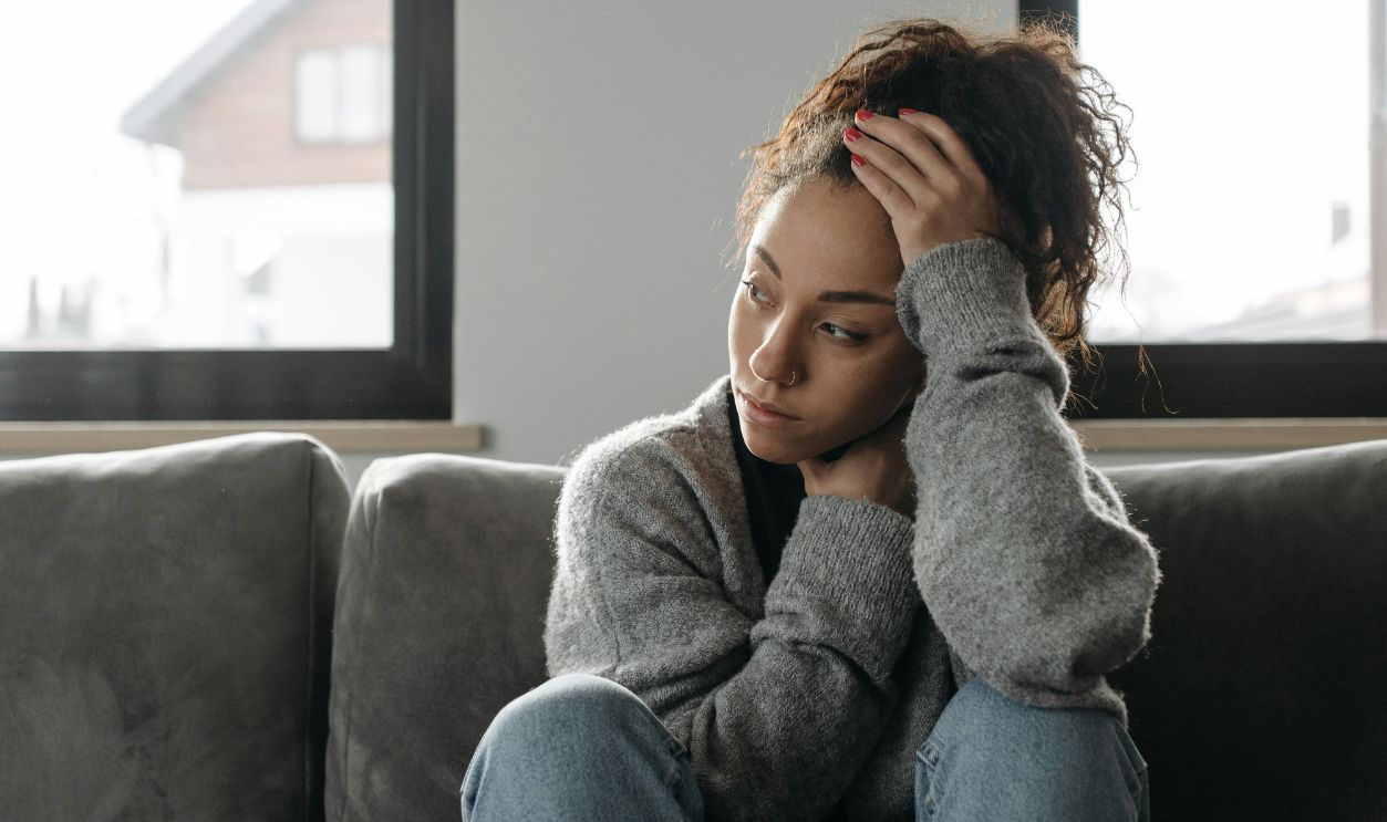 Woman in gray sweater and blue denim jeans