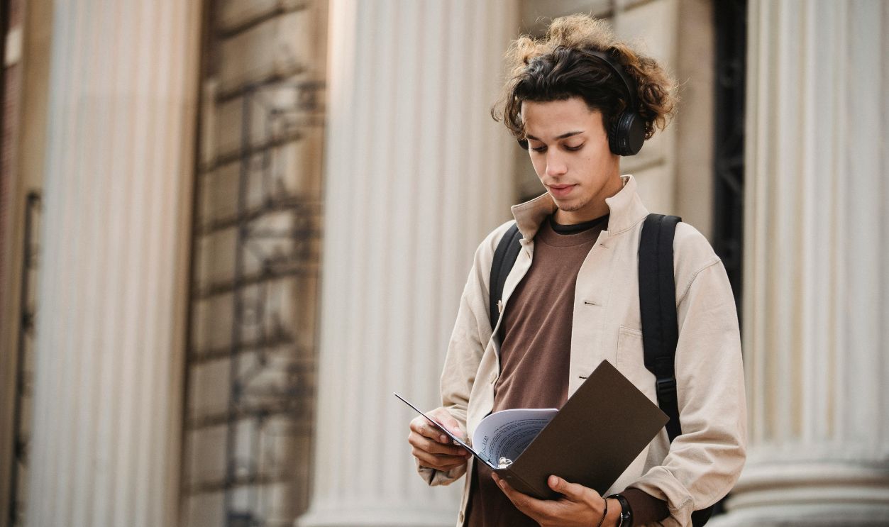 Serious student reading documents in folder