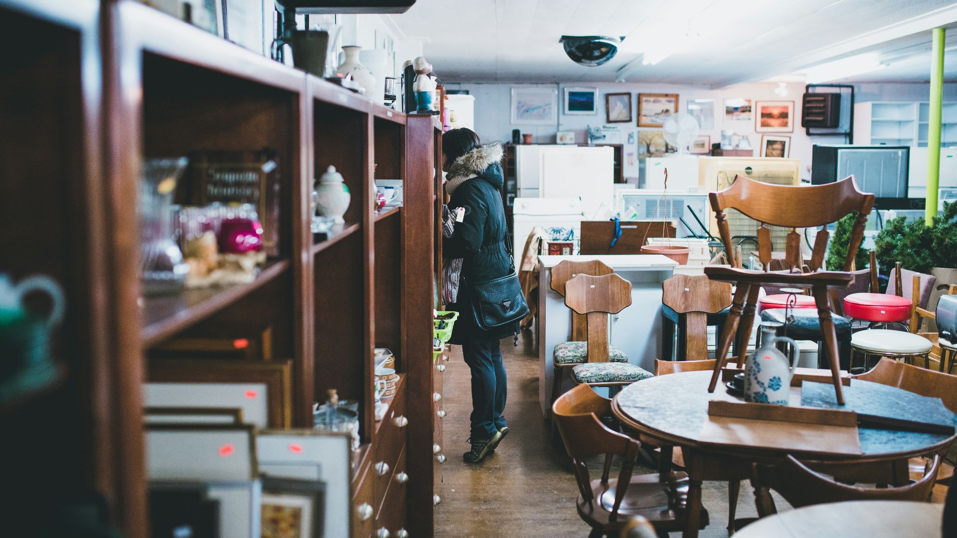 woman standing beside shelf