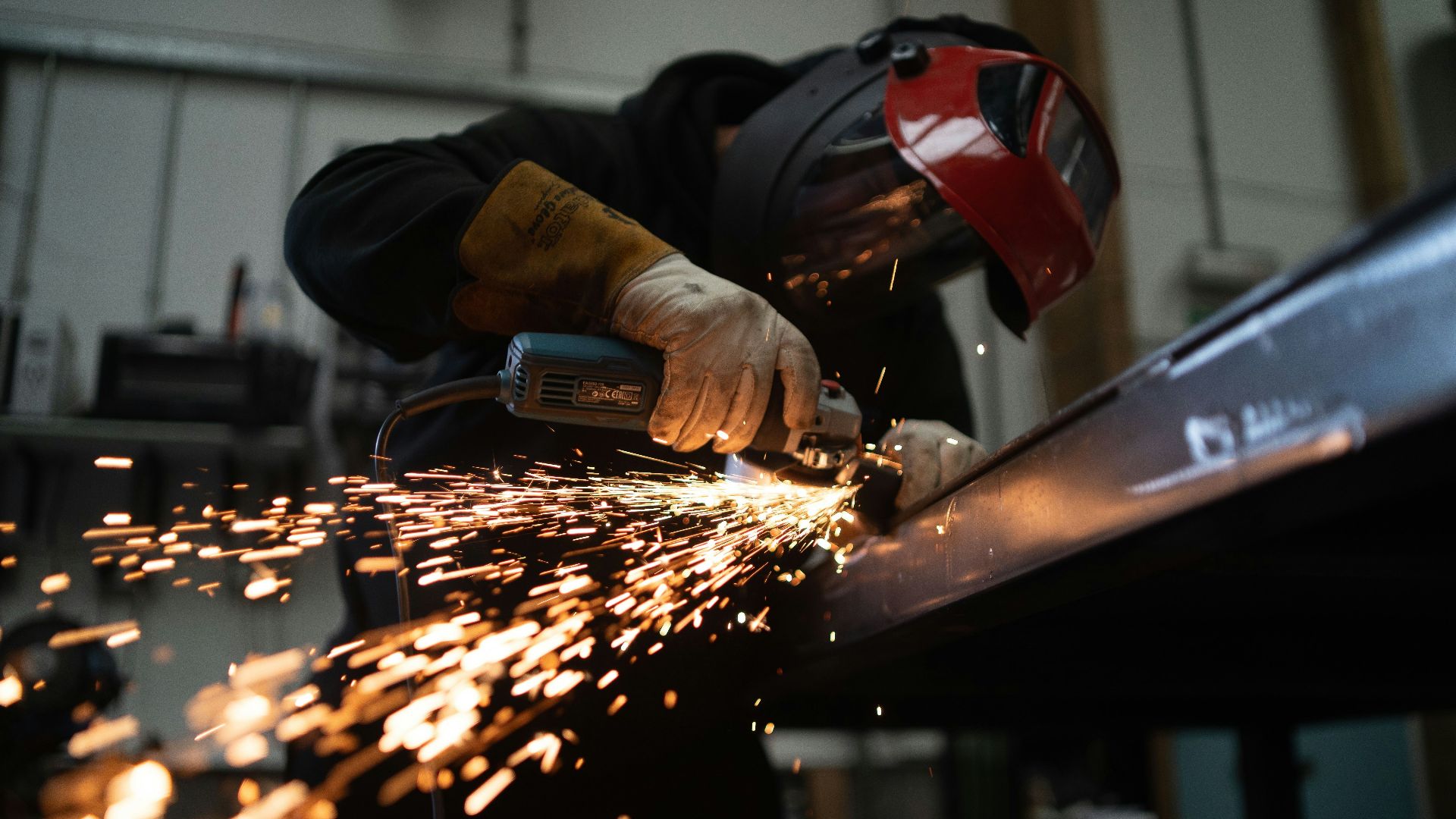 person in black jacket holding brown wooden rolling pin