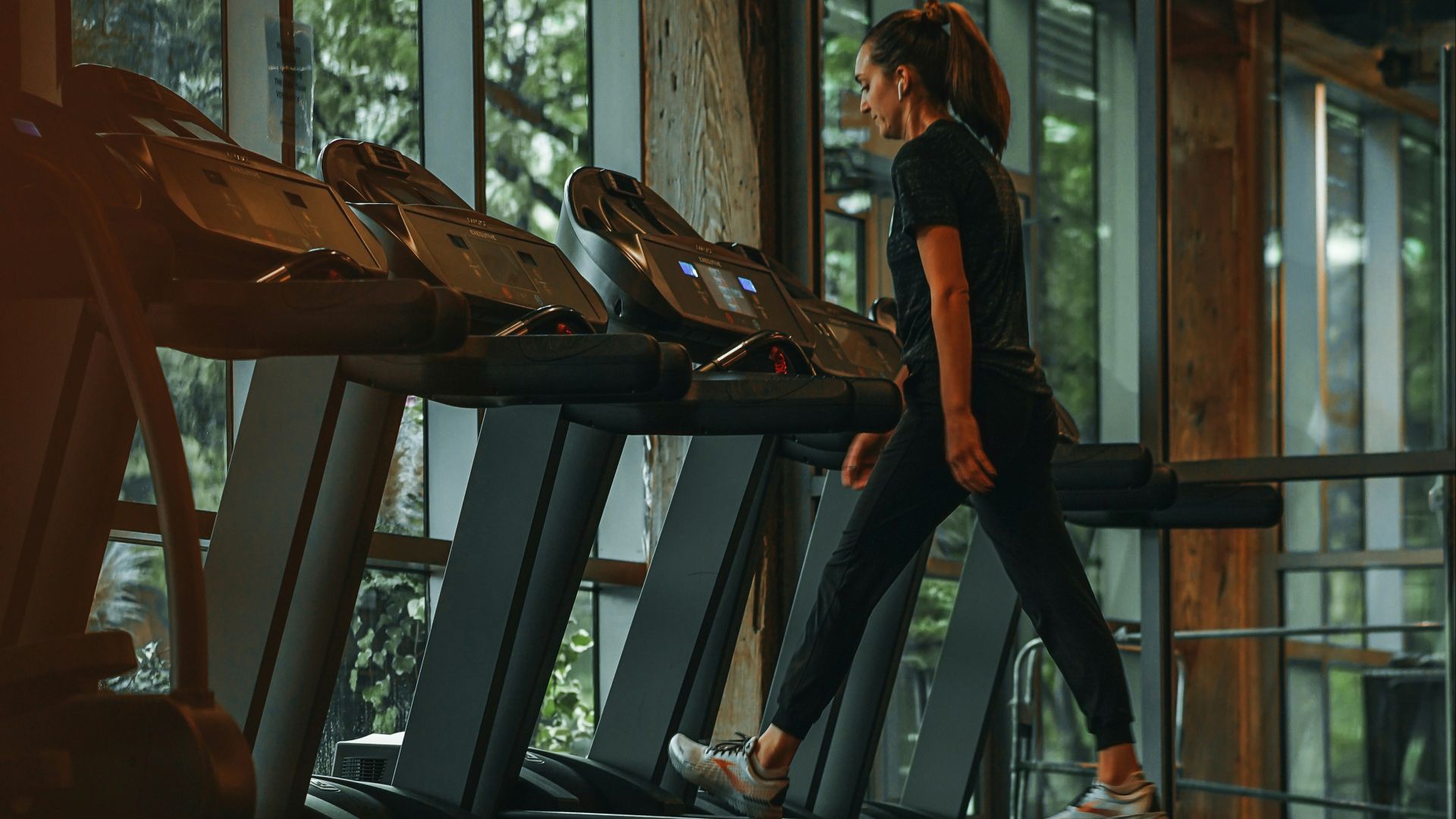 a woman running on a treadmill in a gym