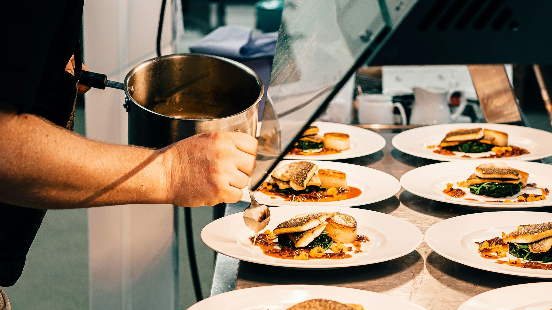 man in black t-shirt holding stainless steel bowl