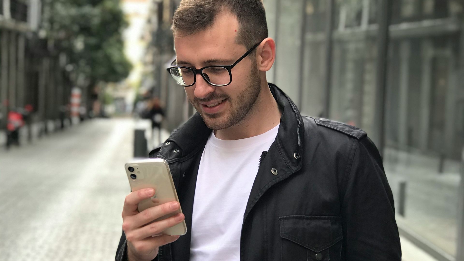 man in black full-zip jacket using smartphone