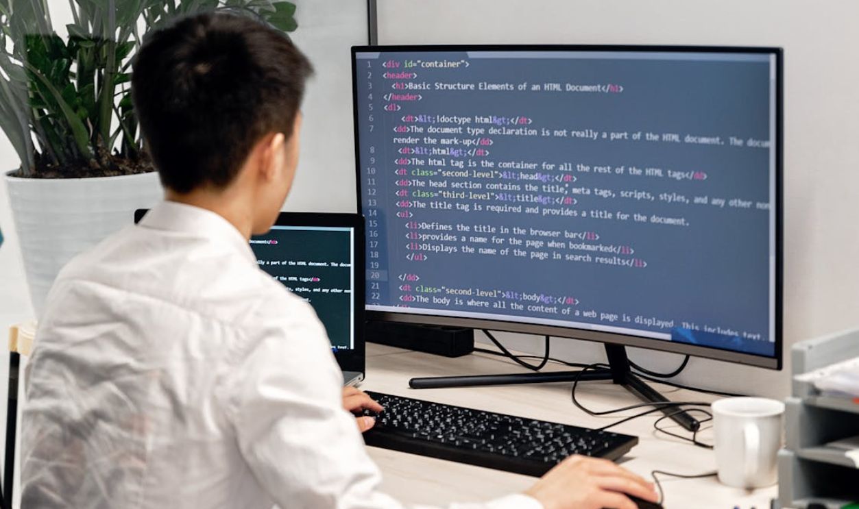 Back View Shot of a Man Working on His Computer