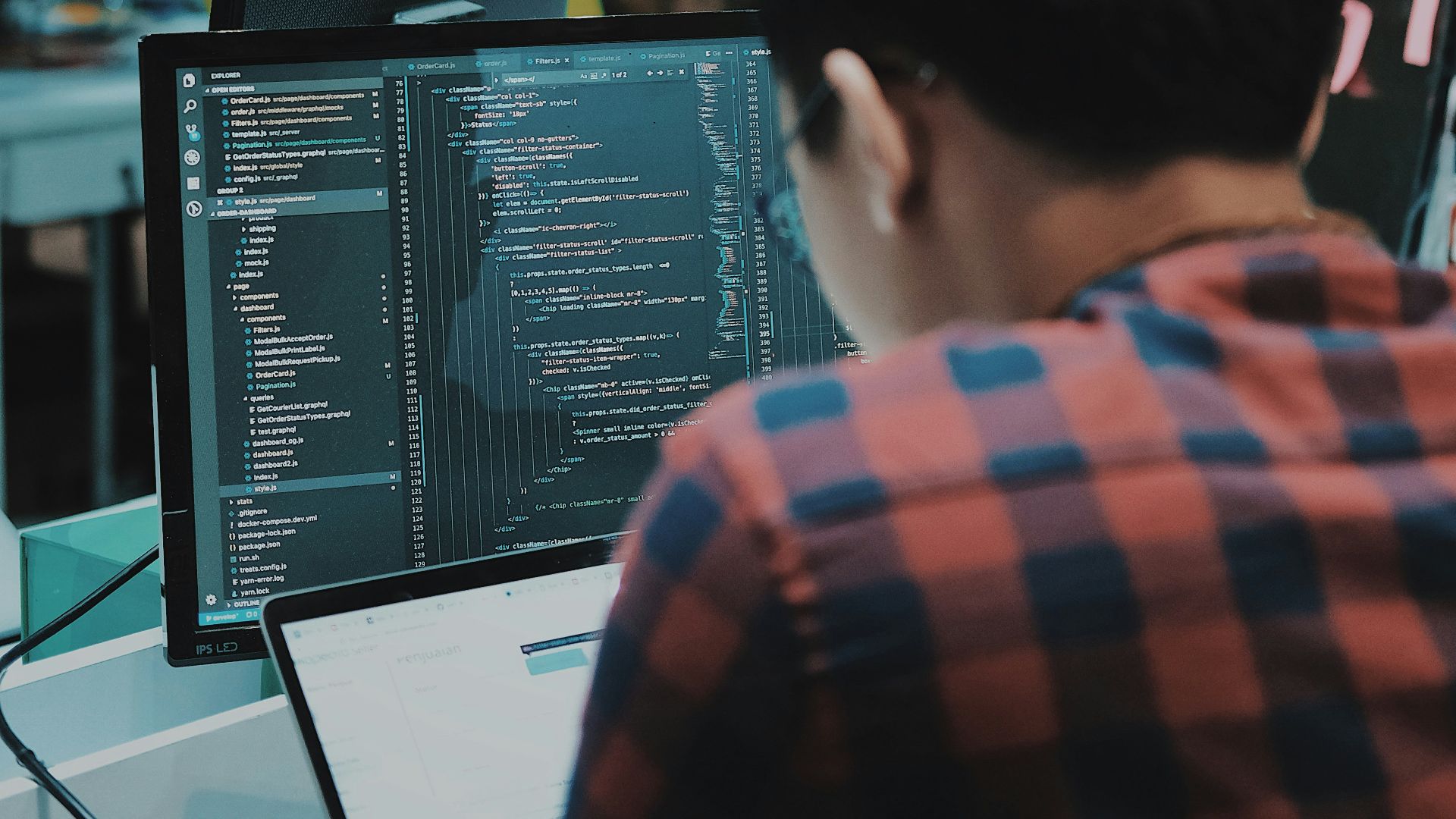 sitting man using gadget in room