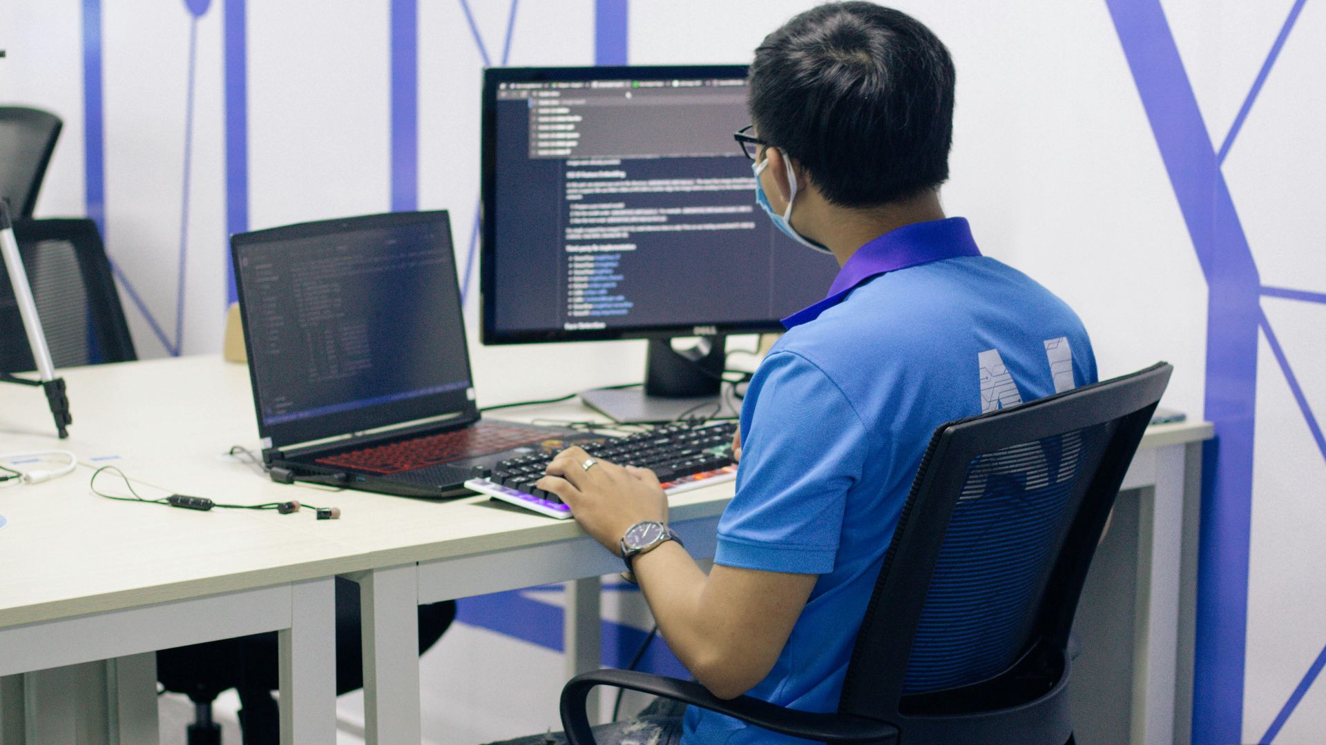 boy in blue t-shirt sitting on black office rolling chair in front of computer