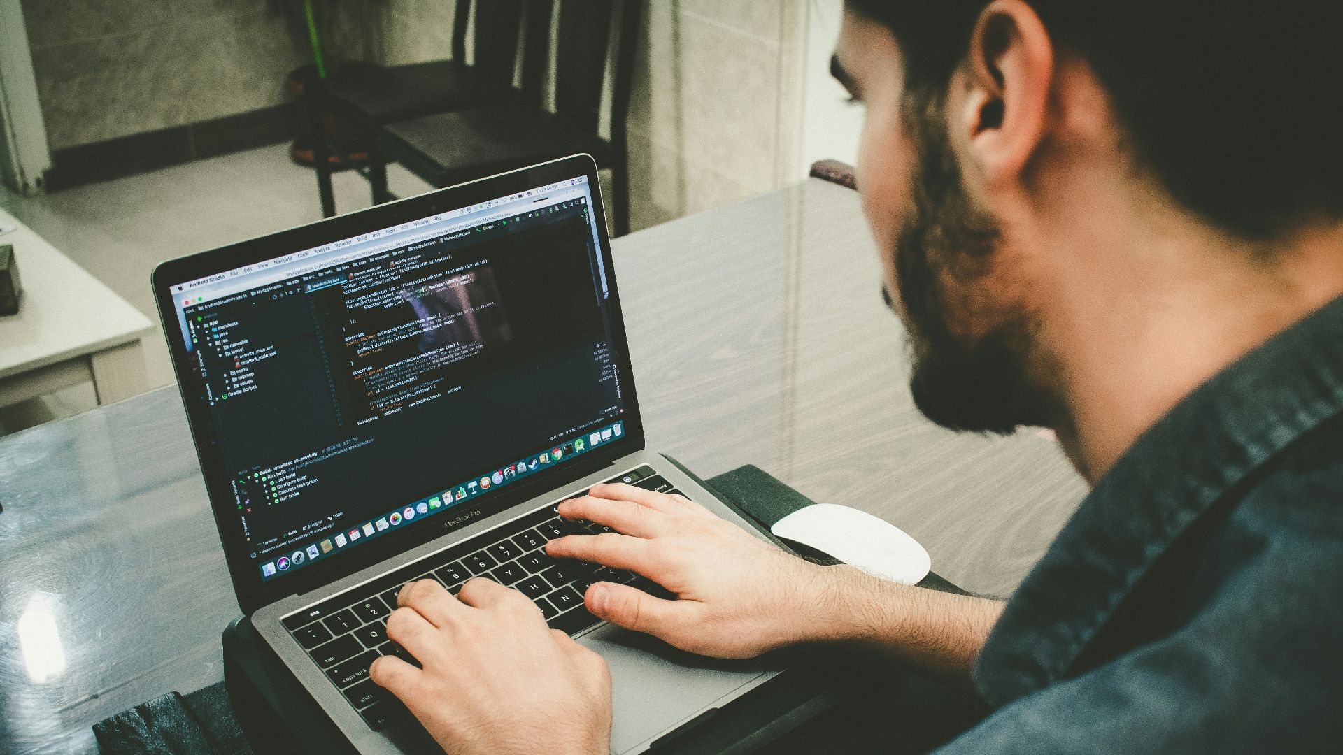 man programming using laptop