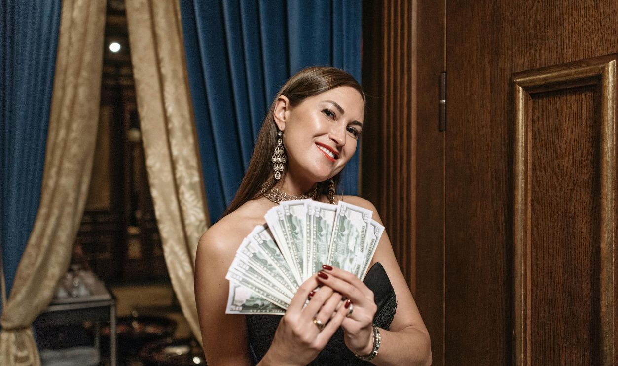 A Woman Smiling holding a money