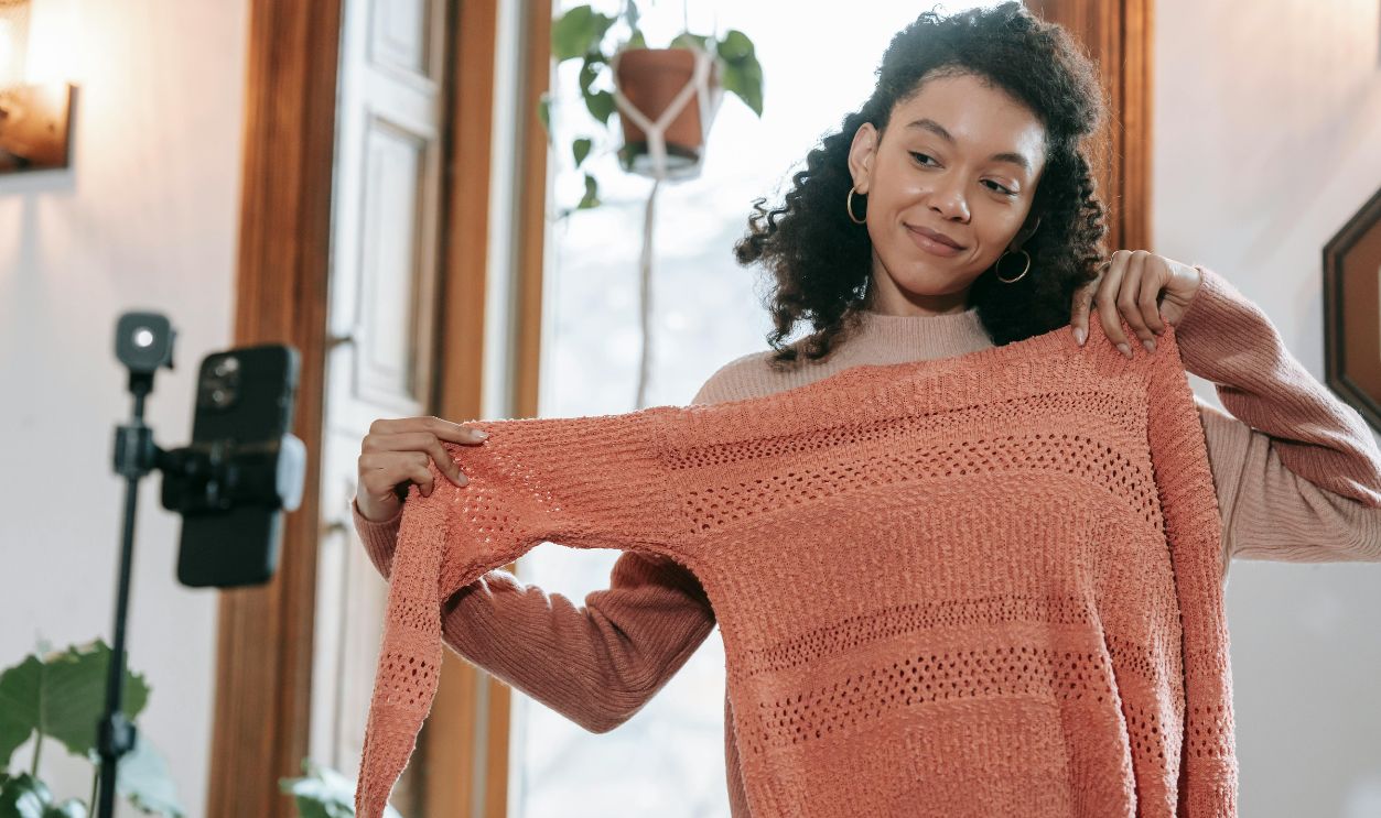 woman trying on sweater