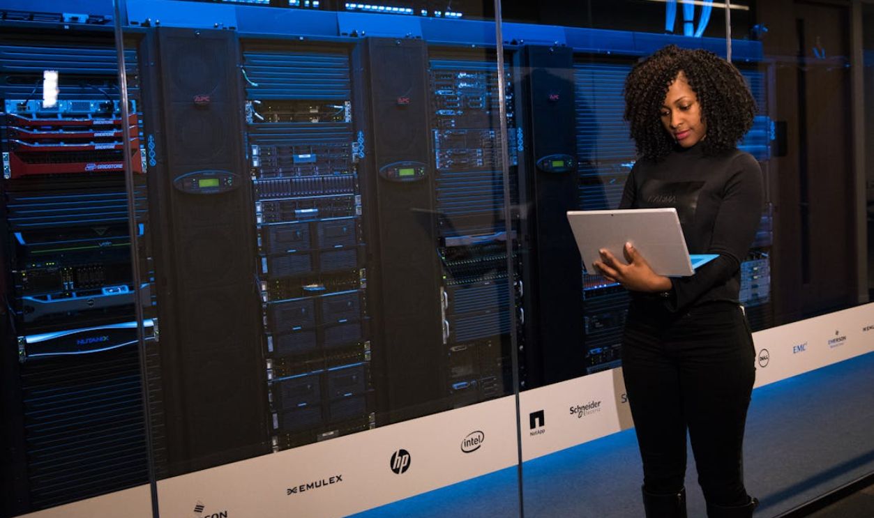 Software Engineer Standing Beside Server Racks