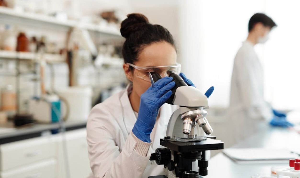 A Woman Using Microscope