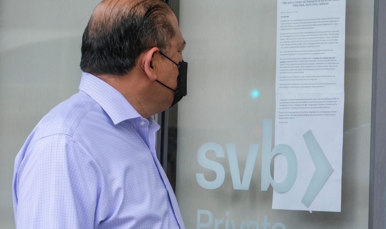 A man takes a closer look at a notice displayed at the window of a Silicon Valley Bank (SVB) in Pasadena, California, Monday, March 13, 2023.  