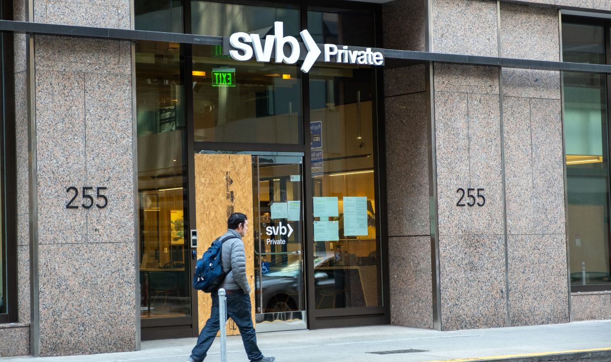 San Francisco, CA, USA, March 17, 2023: SVB Silicon Valley Bank Private Wealth boarded up, broken in, man walking by