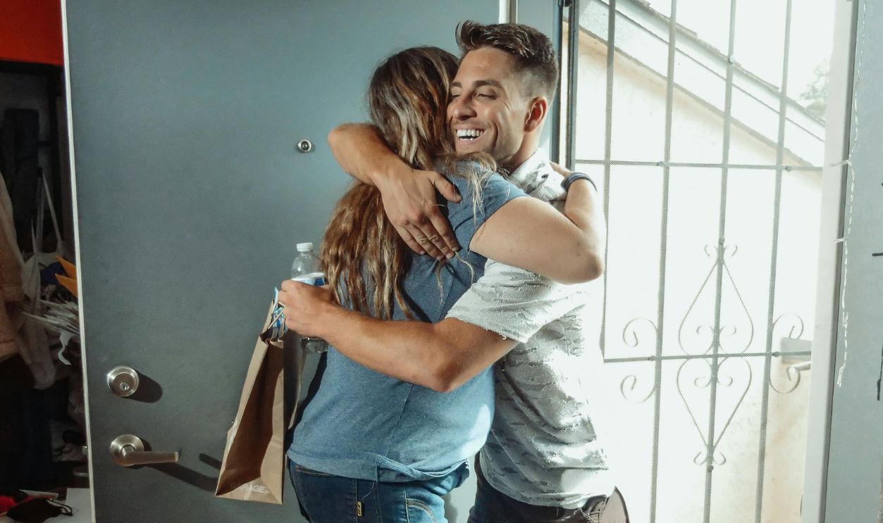 Couple hugging at the door