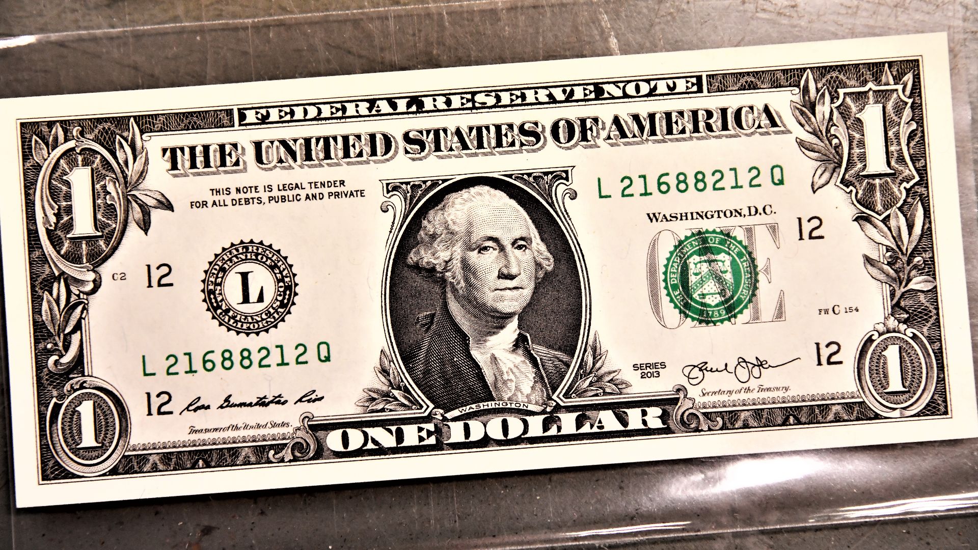 Woman holding a one dollar bill