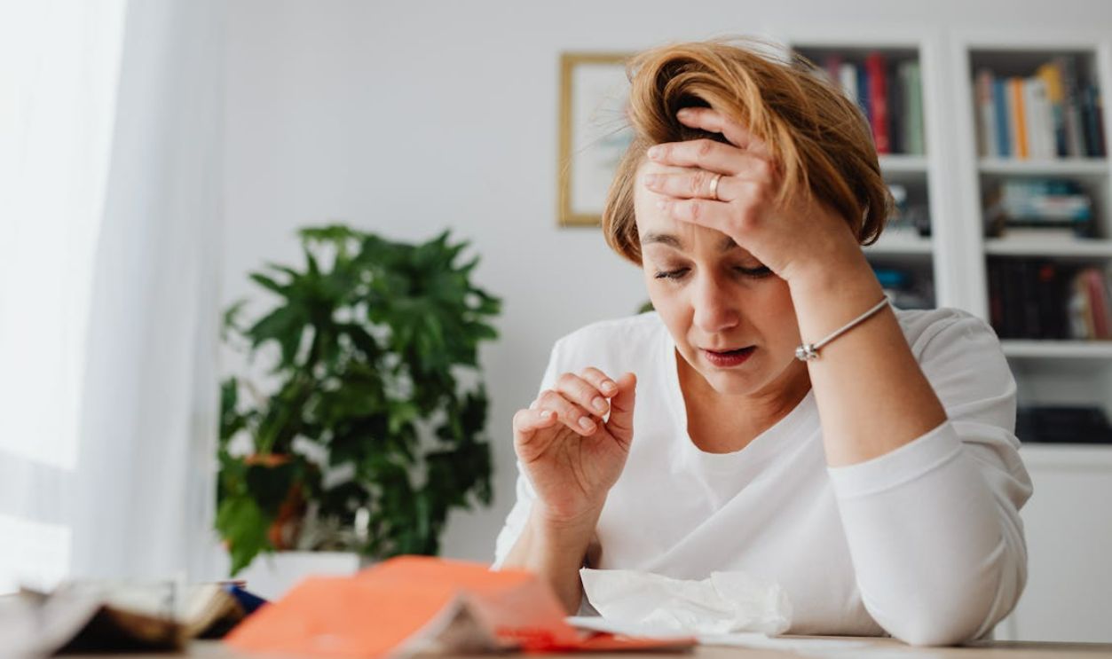 Stressed woman with bills