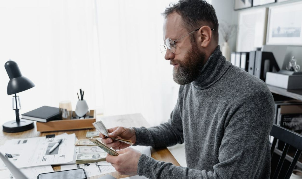 Man counting dollar bills