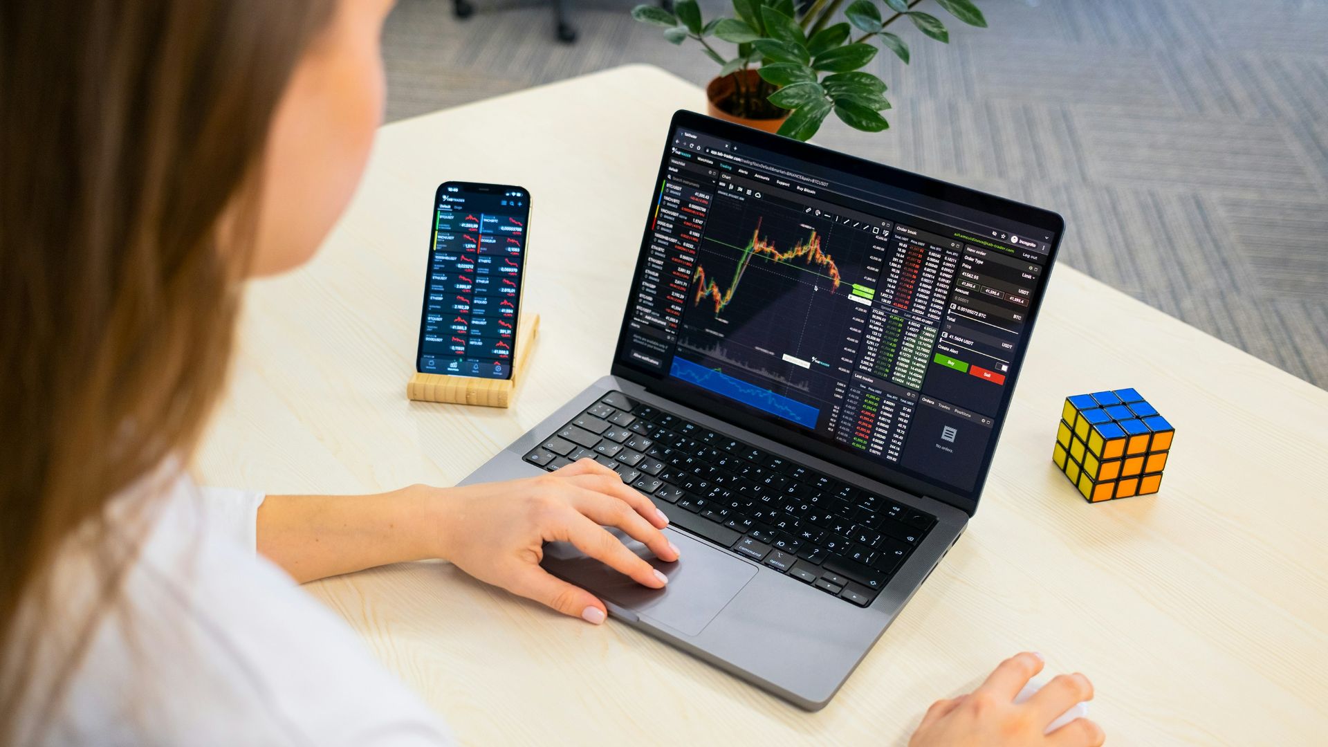 a woman sitting at a table using a laptop computer
