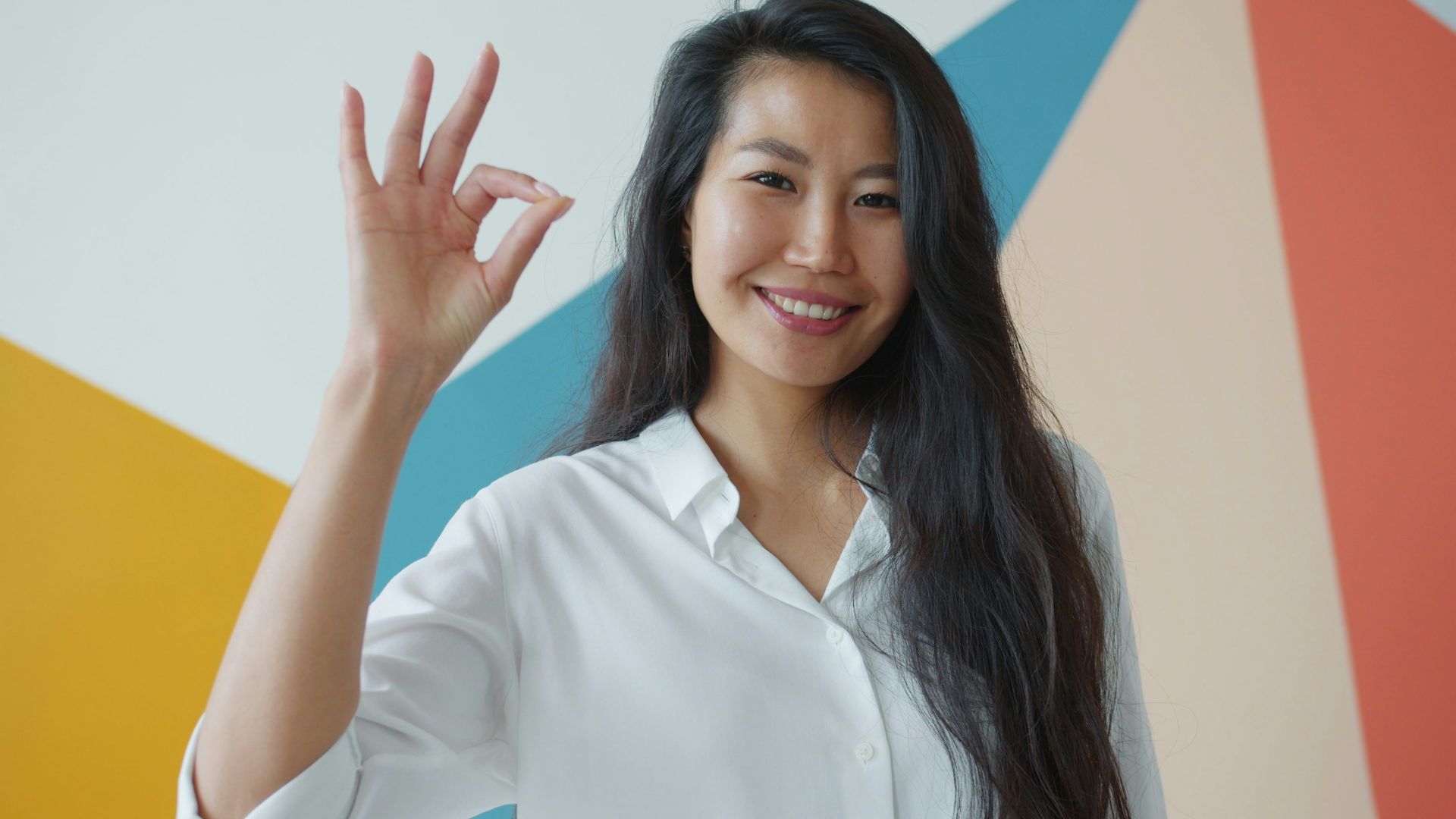 Woman making an ok sign with her hand.