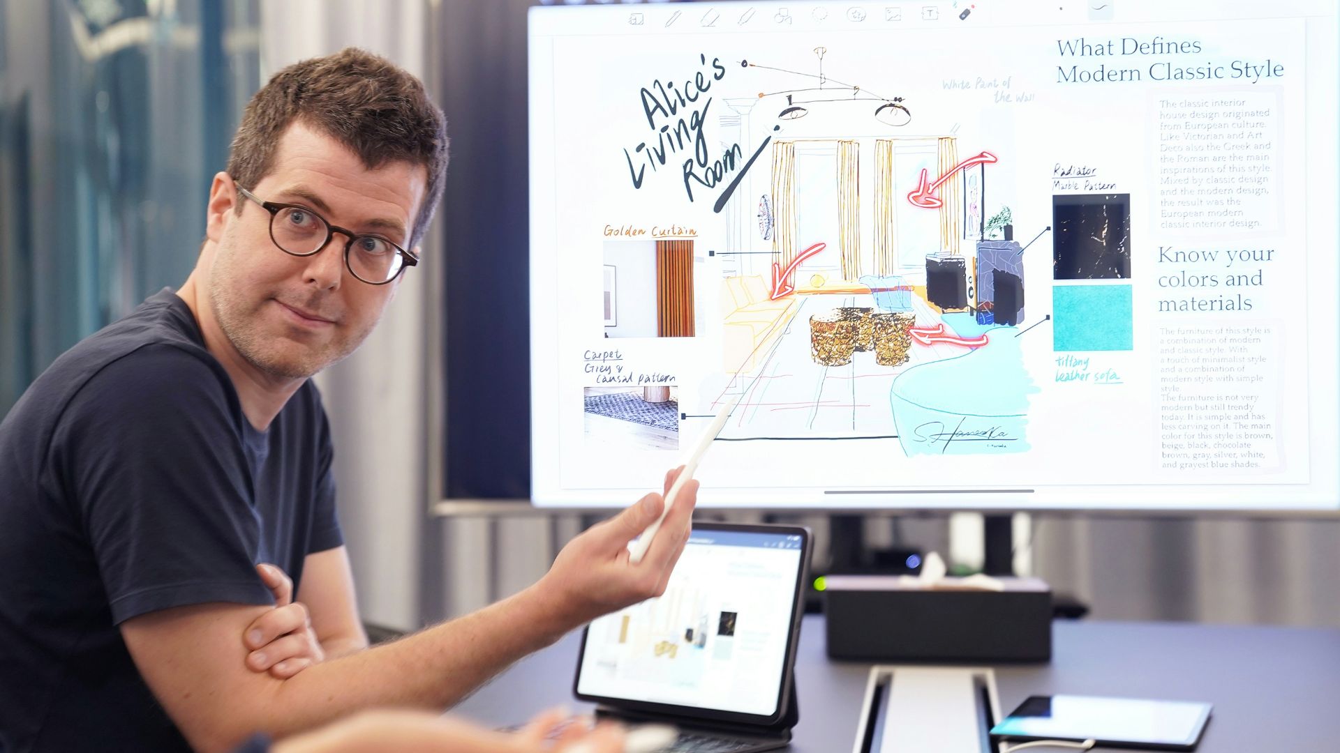 a man sitting at a desk with a laptop and a white board