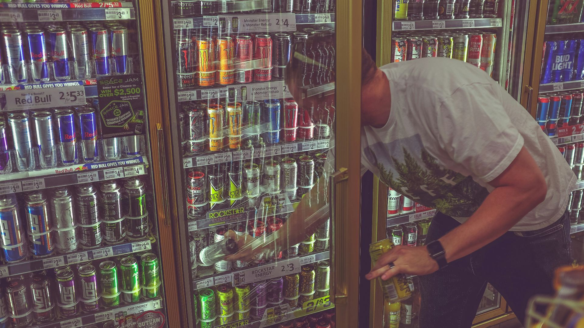 man getting can in beverage cooler