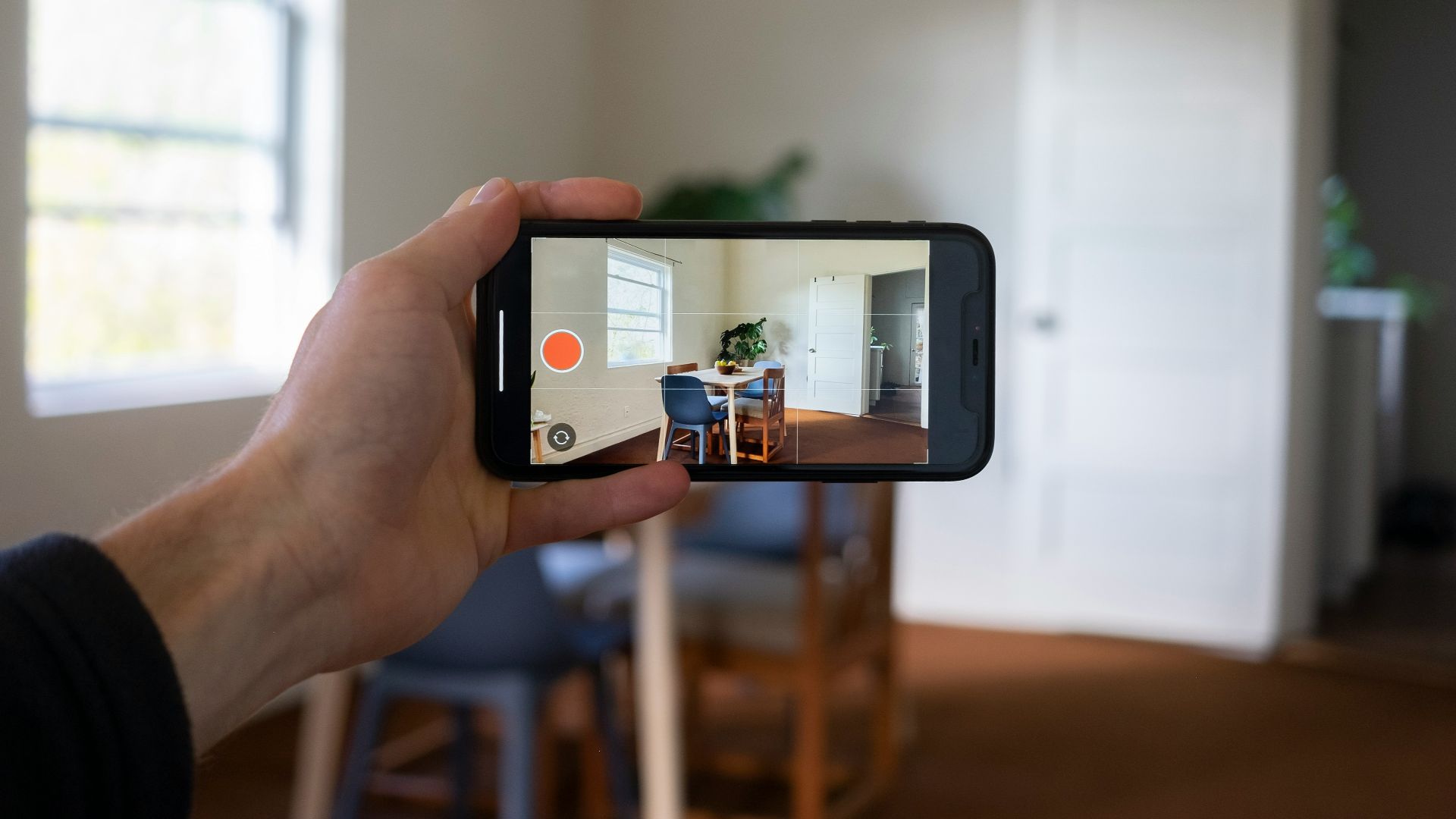 a person holding a smart phone up to take a picture