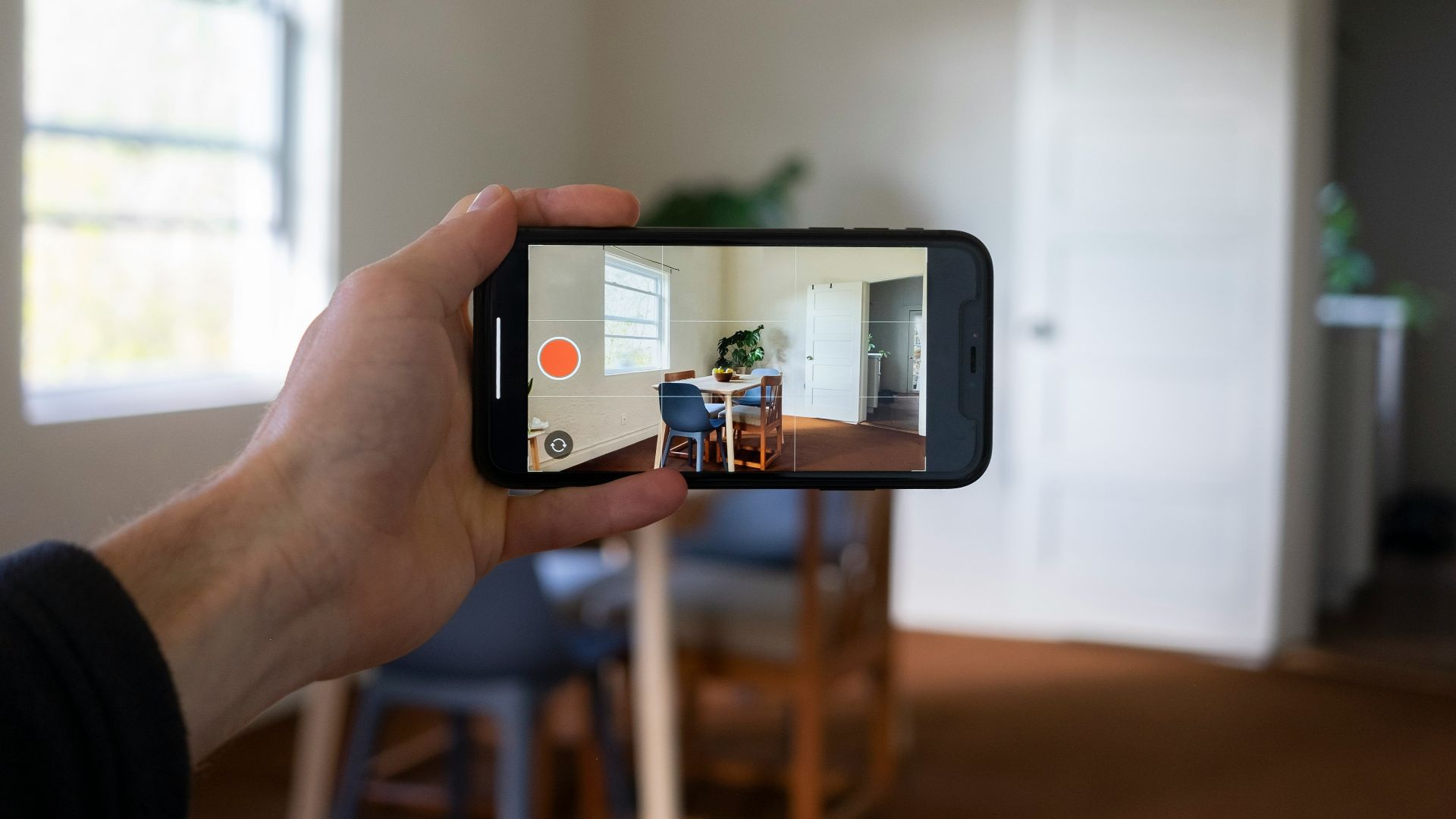 a person holding a smart phone up to take a picture