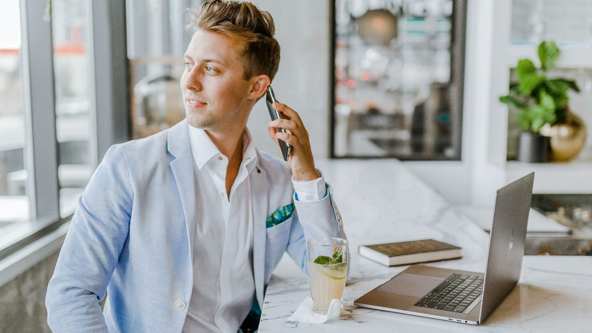 man sitting beside white wooden table
