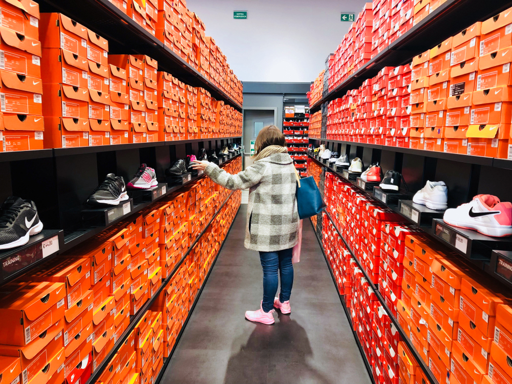 A woman shopping shoes at the La Roca Village Nike Store