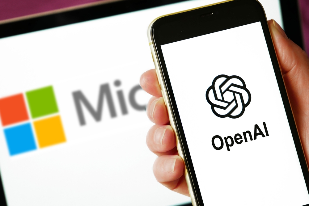Hand holding smartphone with OPENAI logo on screen