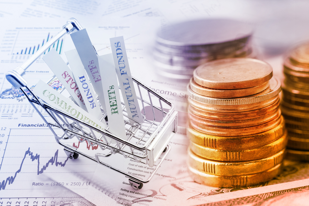 Stack of coins and a trolley with various types of financial investment products