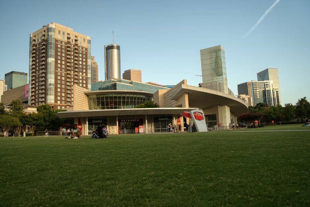 Locals and tourists walking in and out of World of Coca Cola