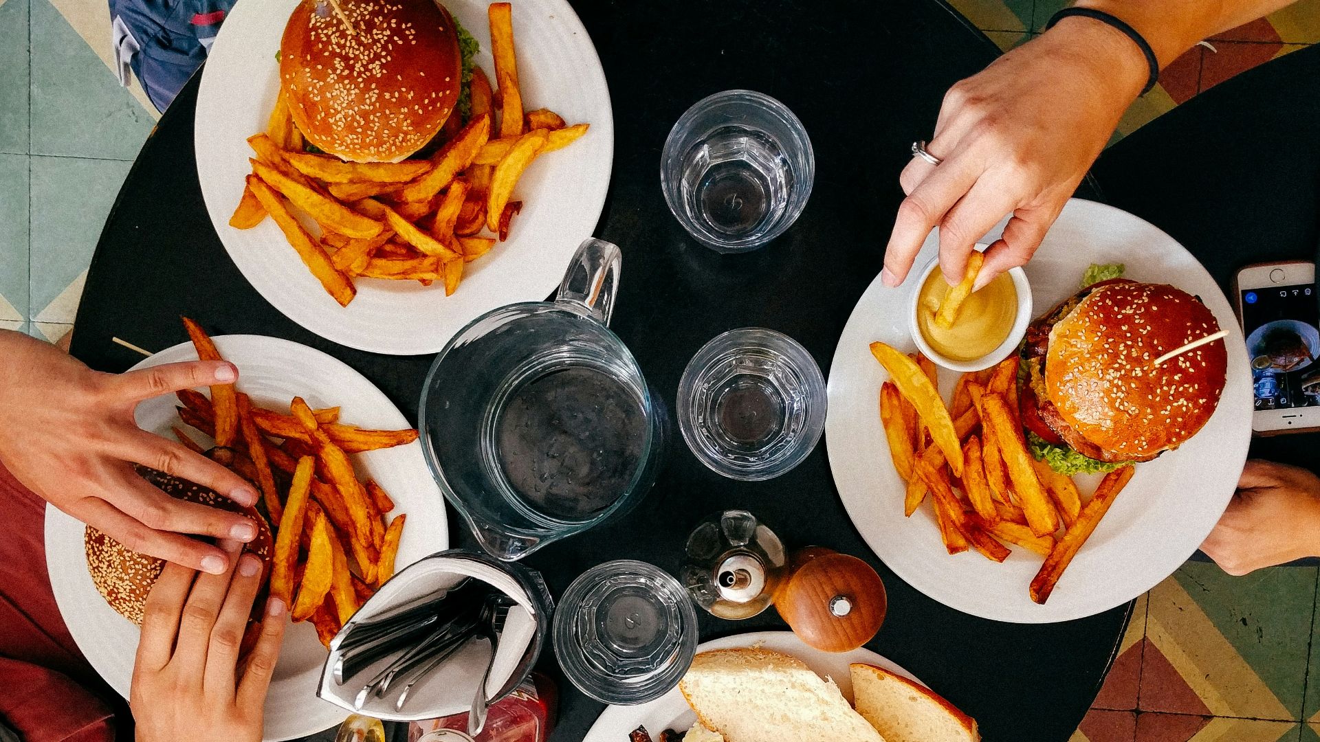 four person earring on black wooden table