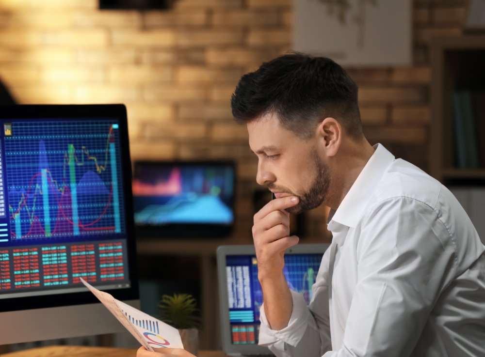 Young stock exchange trader working in office