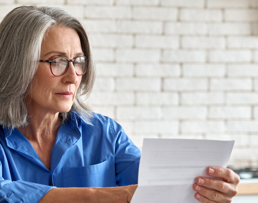 Adult senior 60s woman working at home at laptop