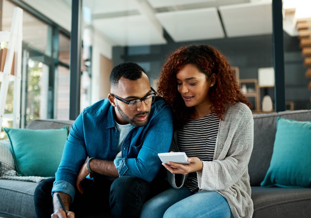 Calculator, financial checklist or couple writing with budget paperwork