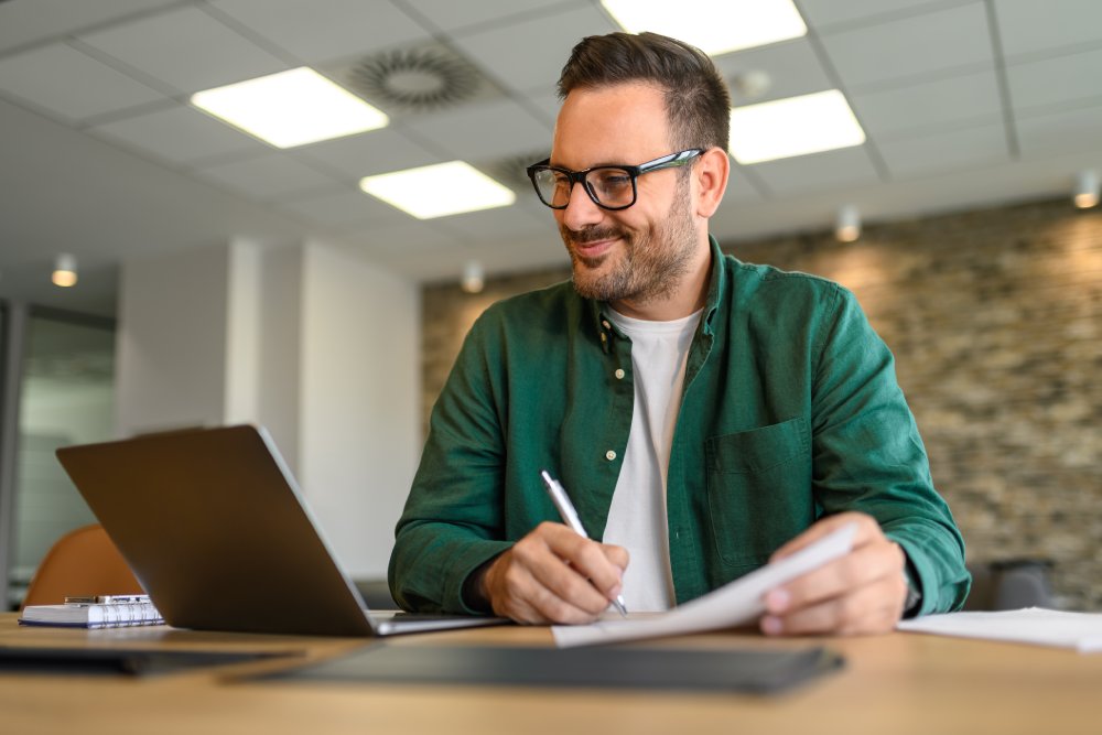 Portrait of financial analyst examining report and working on new strategies