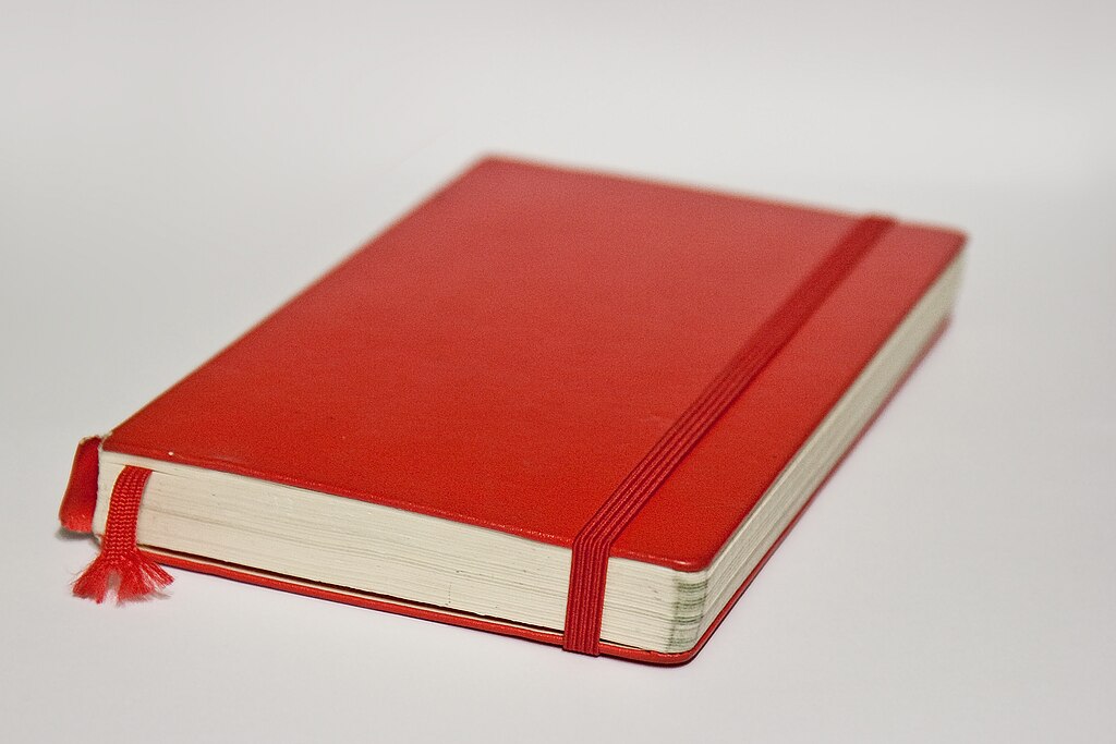Red Moleskine notebook.
