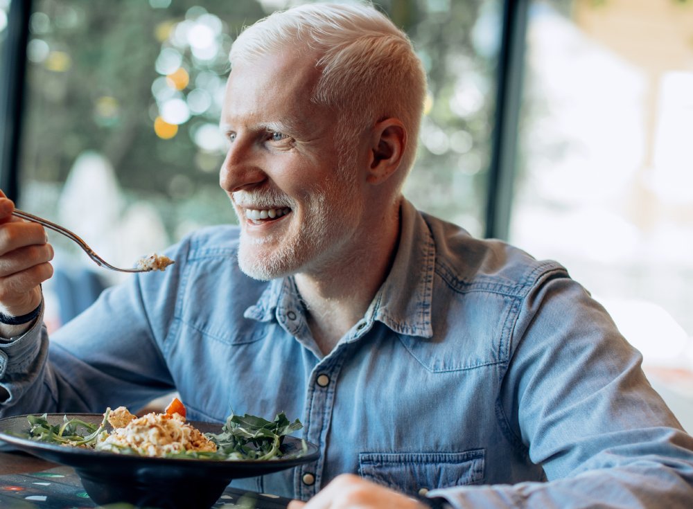 Portrait Photo of Man eating healthy meal in the restaurant