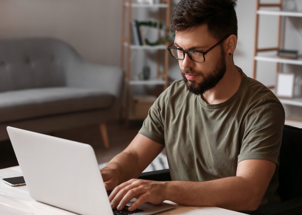 Portrait Photo of Freelancer working on laptop at home office