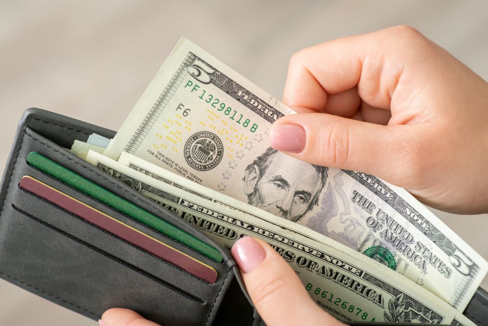 Close Up Photo of Woman gets american money from the wallet
