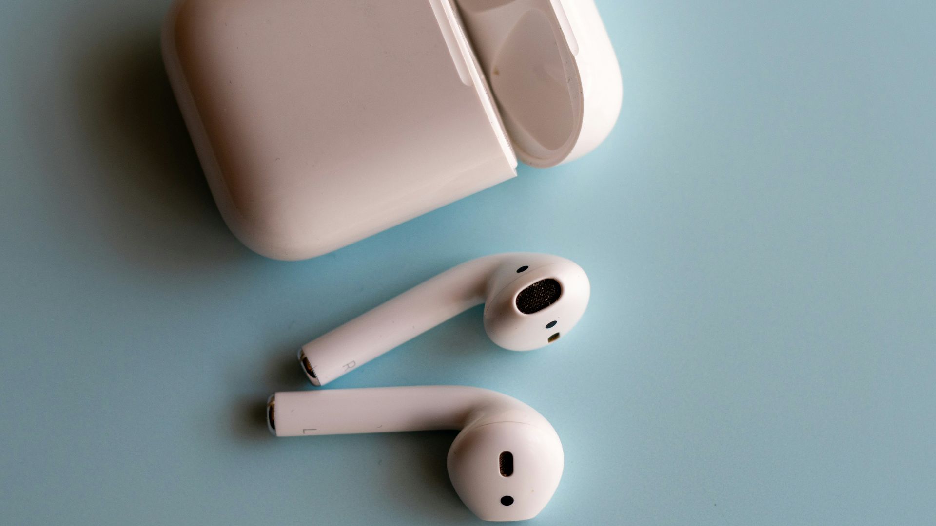 white apple earpods on white surface
