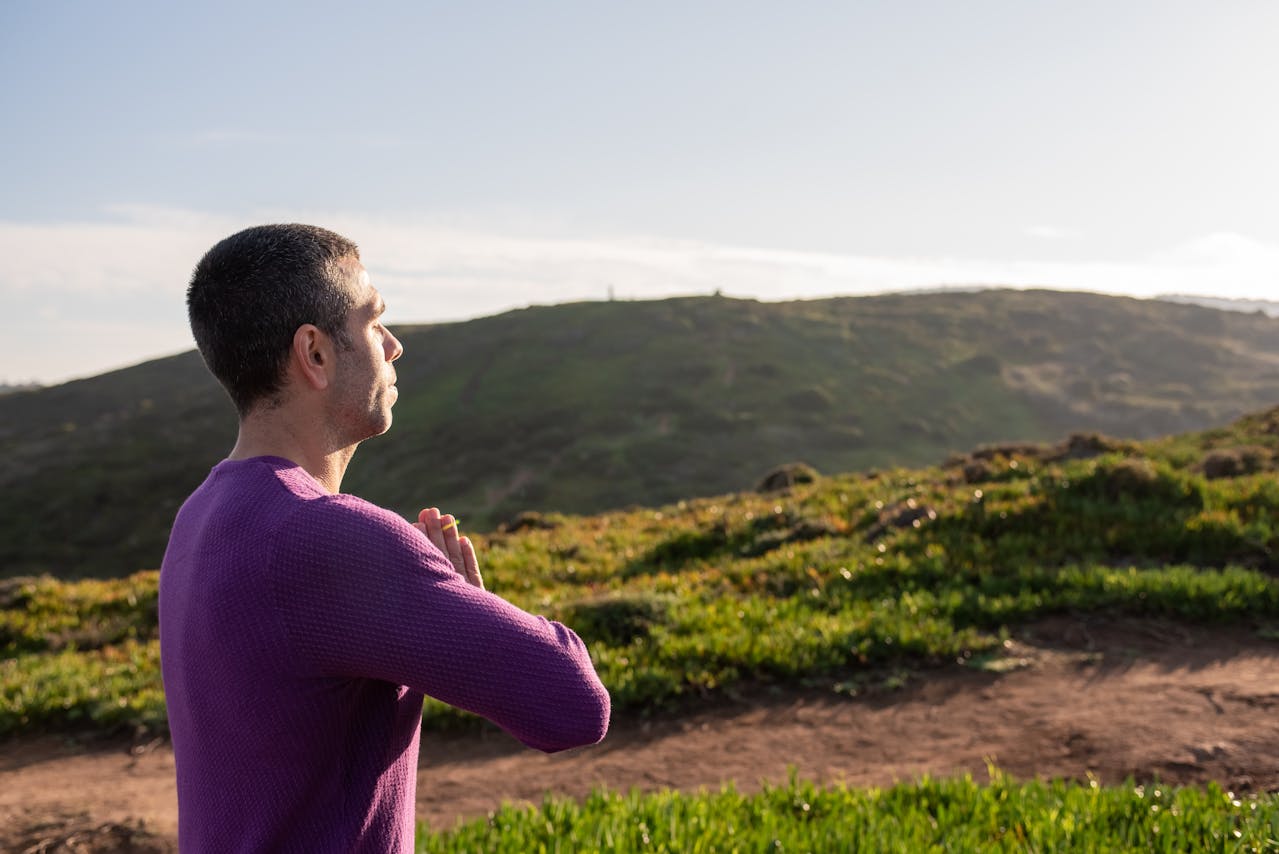 A Man Doing Yoga on a Mountain